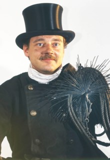 Chimney sweep in professional training and posing in a photo studio