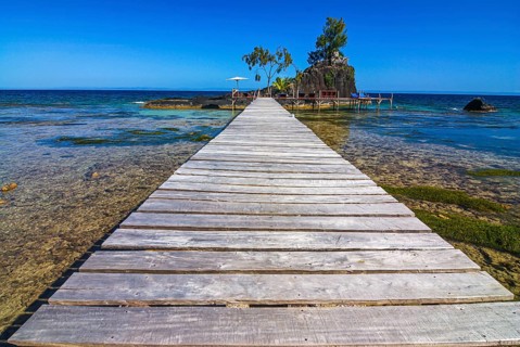 Pier to little islet on the coastline of the Island Ile Sainte Marie