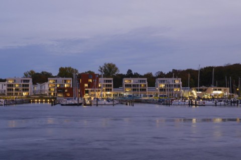 Marina and illuminated modern buildings at Priwall