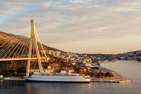 Sunset over Dubrovnik with bridge and cruise ship