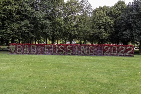 Frame with Bad Fuessing lettering made of flowers with a red background of cyclamen