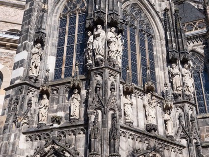The magnificent church facade of the UNESCO World Heritage Aachen Cathedral with large human figures
