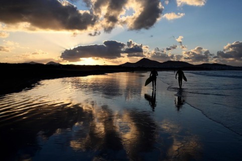Surfers on the beach of Caleta de Famara