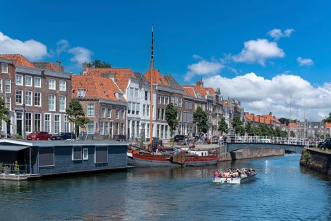Cityscape with houseboat and traditional flat-bottomed sailing boat at Bierkaai