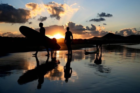 Surfers on the beach of Caleta de Famara
