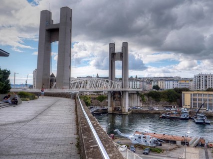 Largest vertical lift bridge in Europe in Brest 'Pont de Recouvrance' over the river Penfeld. A giant helicopter is on display under the bridge