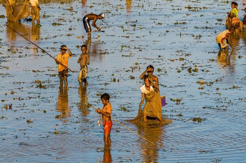 Locals fishing in a shallow lake
