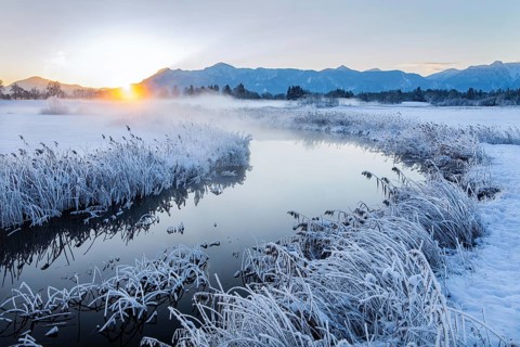 Snowy winter landscape with the Uffinger Ach at sunrise with Herzogstand 1731m and Heimgarten 1790m