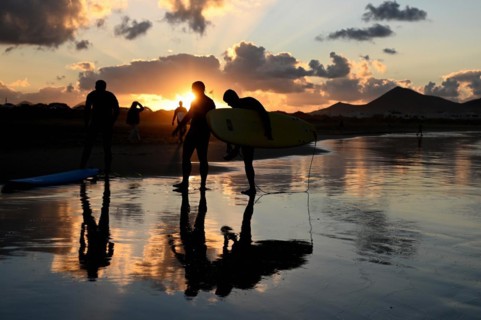 Surfers on the beach of Caleta de Famara