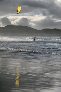 Kitesurfers at sunset on the beach of Caleta de Famara
