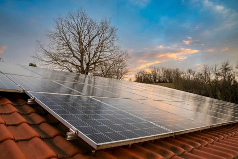 Photovoltaic system on tiled roof in evening light