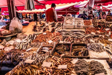 Historic fish market La pescheria with a cornucopia of colourful sea creatures