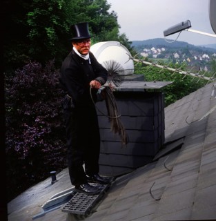 Chimney sweep in professional training and posing in a photo studio