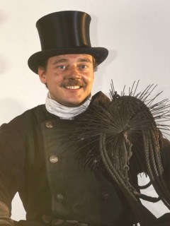 Chimney sweep in professional training and posing in a photo studio