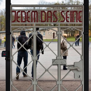 Visitors at the gate to the camp in the former beech forest concentration camp
