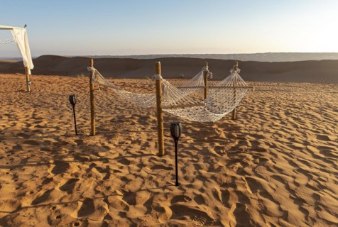 Two hammocks in desert camp