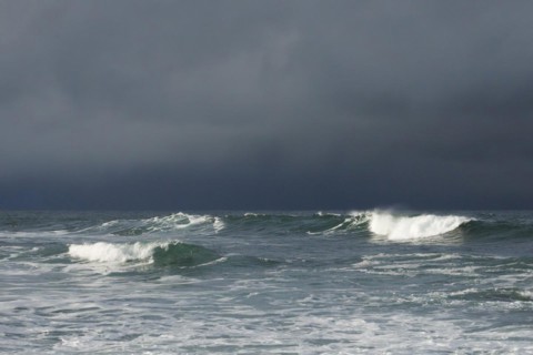 Big waves crashing in the open sea and dramatic light off the north coast of Ireland