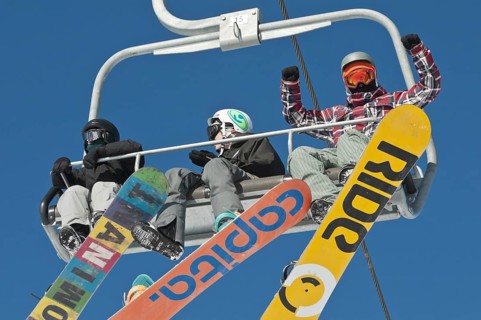 Snowboarders on a ski lift