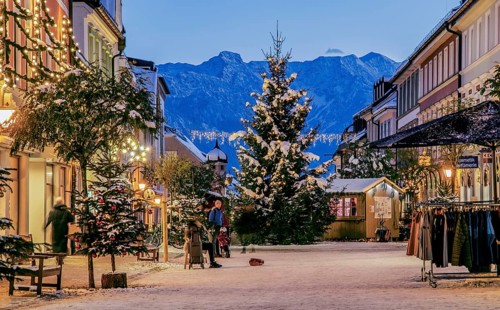 Winter Obermarkt in the snow with Christmas tree and Christmas lights in front of the Hoehen Kiste 1922m in the Estergebirge
