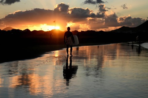Surfers on the beach of Caleta de Famara