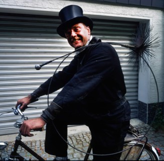 Chimney sweep in professional training and posing in a photo studio