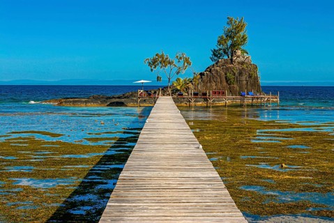Pier to little islet on the coastline of the Island Ile Sainte Marie