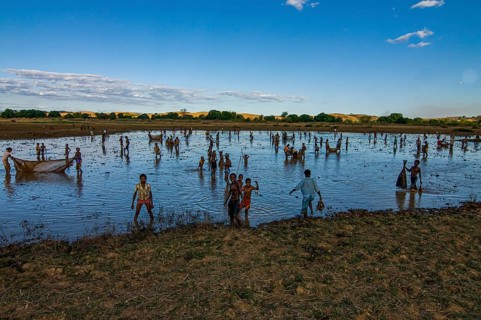 Locals fishing in a shallow lake