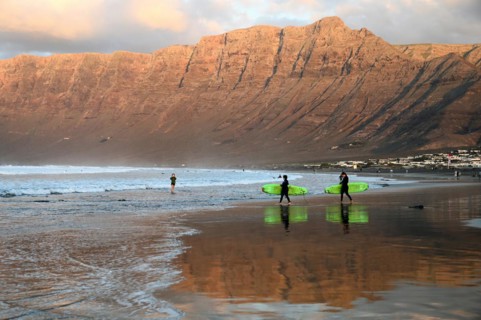 Surfers on the beach of Caleta de Famara