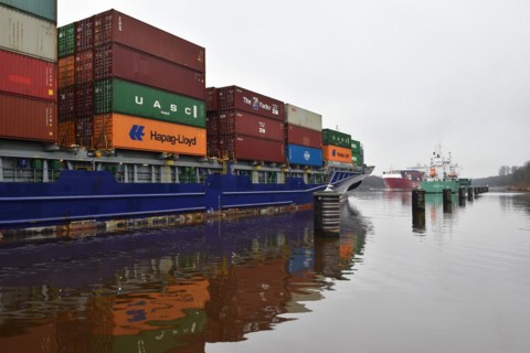 Container ship Munksund waits in a passing place for oncoming traffic in the Kiel Canal