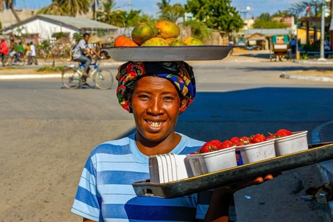 Freindly woman selling fruits on the street