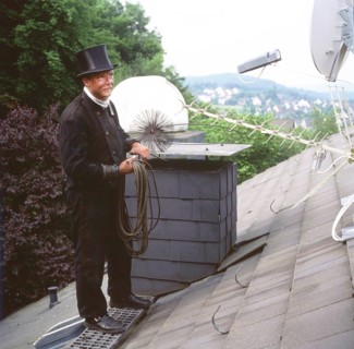 Chimney sweep in professional training and posing in a photo studio