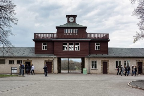 Visitors at the gate to the camp