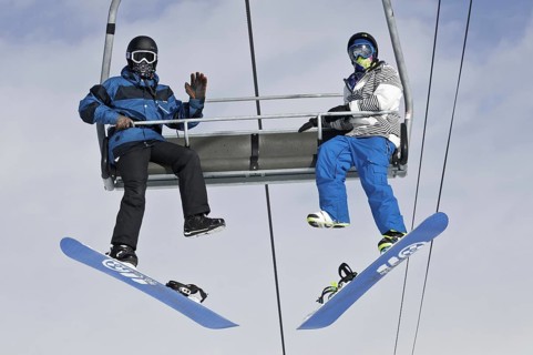 Snowboarders on a ski lift