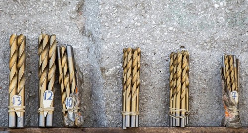 Drill bits grouped into different sizes in view