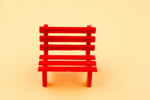 Little red miniature bench made of plastic