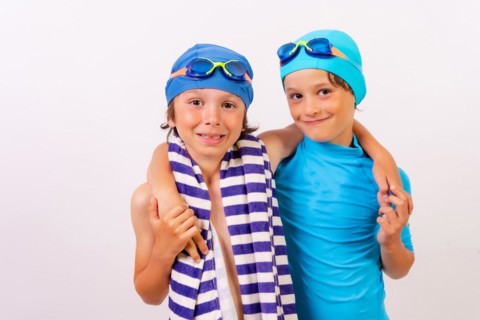 Brothers dressed and hugged in their swimsuits for swimming lessons in the pool in the summer. White background