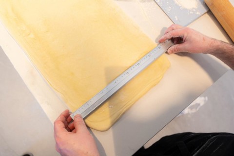 Confectioner man baking homemade croissants