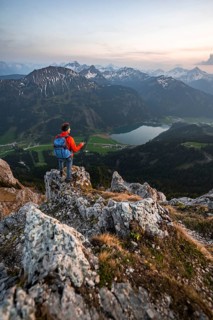 Hiker at the summit of Schartschrofen at sunset