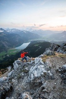 Hiker at the summit of Schartschrofen at sunset