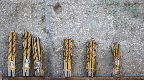 Drill bits grouped into different sizes in view