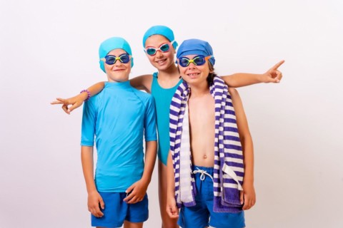 Portrait of brothers dressed in swimsuits for swimming lessons in the pool. White background