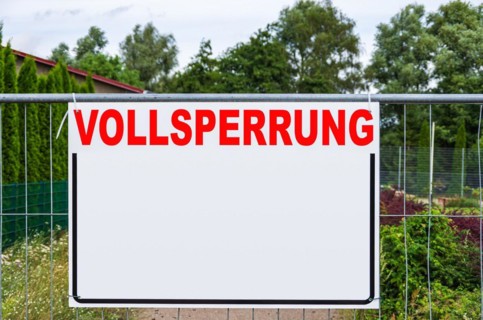 A rectangular board with a lot of free text space with the word FULL EXCLUSION on a construction fence