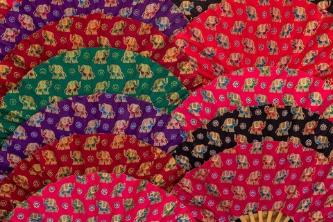 Colourful hand fans as background or texture