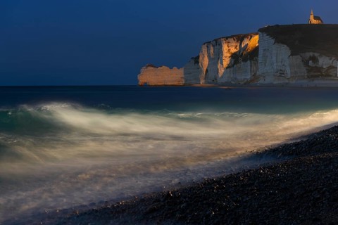 Etretat beach with view of Falaise d'Amont and Chapelle Notre-Dame de la Garde