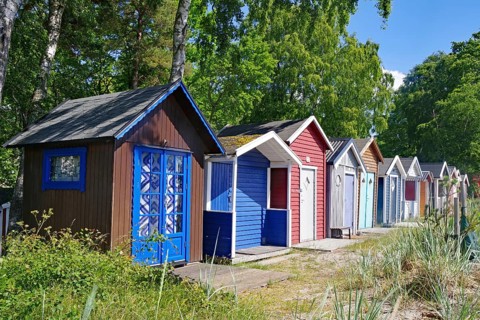 Small beach huts in bright colours