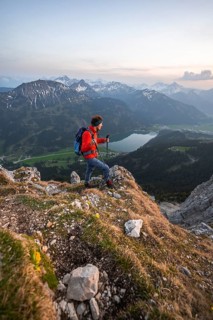 Hiker at the summit of Schartschrofen at sunset