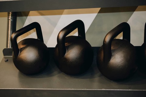 Steel gym kettles on metal stand in the view