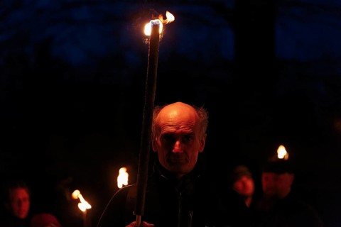 Walkers with torches at night
