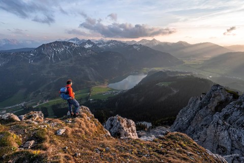 Hiker at the summit of Schartschrofen at sunset