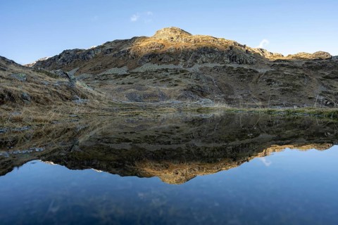 Reflection and view of the mountains at the Bernina Pass